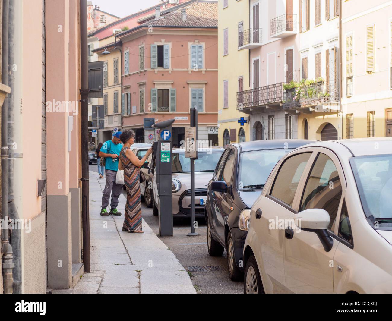 Cremona, Italy - June 21st 2024 Woman paying for street parking at a ...