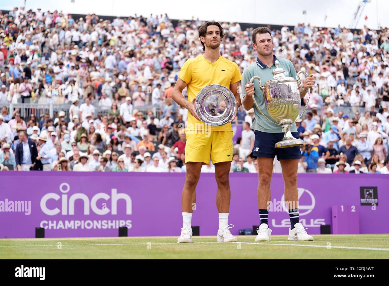 Tommy Paul (right) with the trophy after winning and Lorenzo Musetti (left) with the plate on