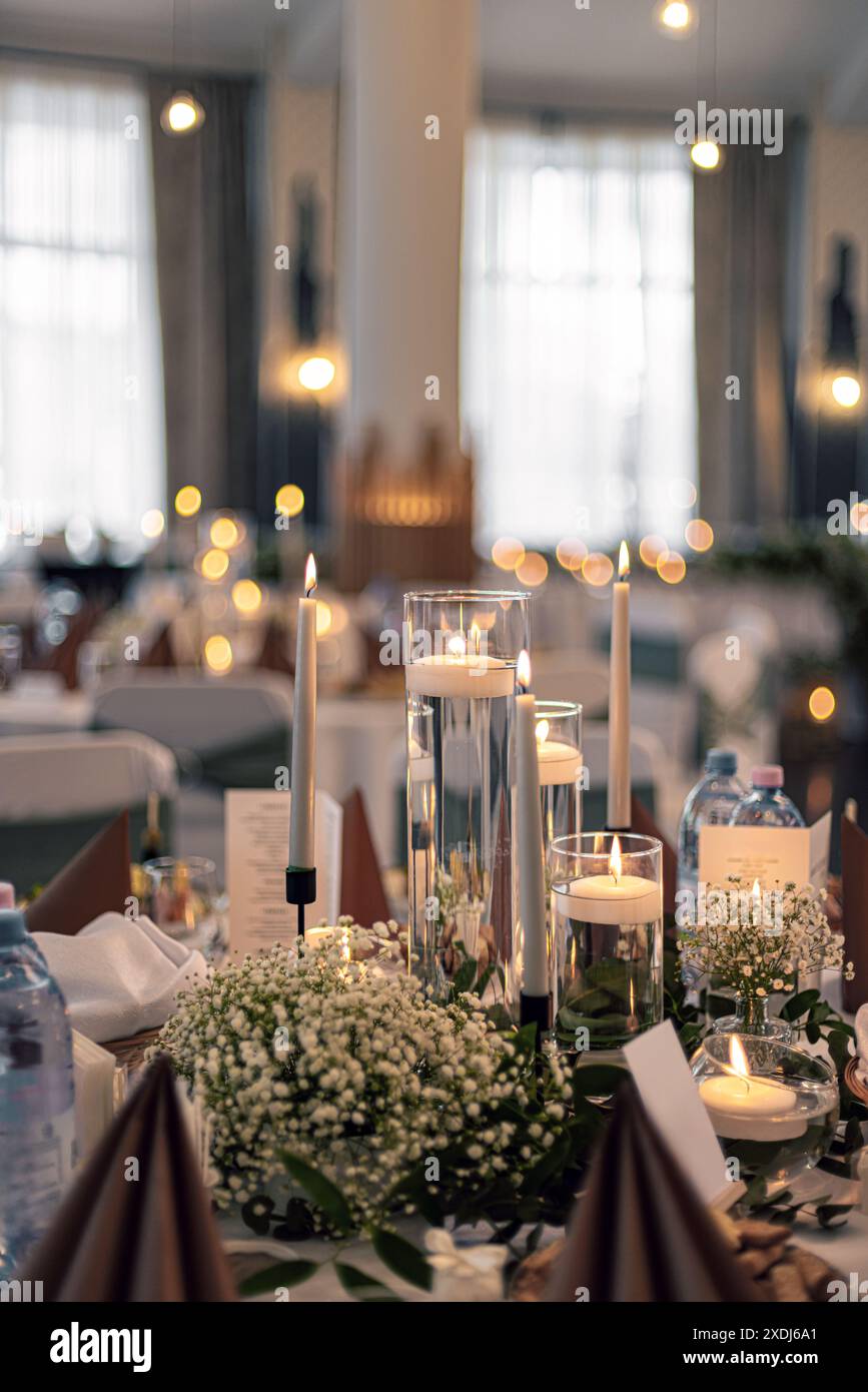 Warm candlelit table setting creates a romantic atmosphere at a wedding table Stock Photo