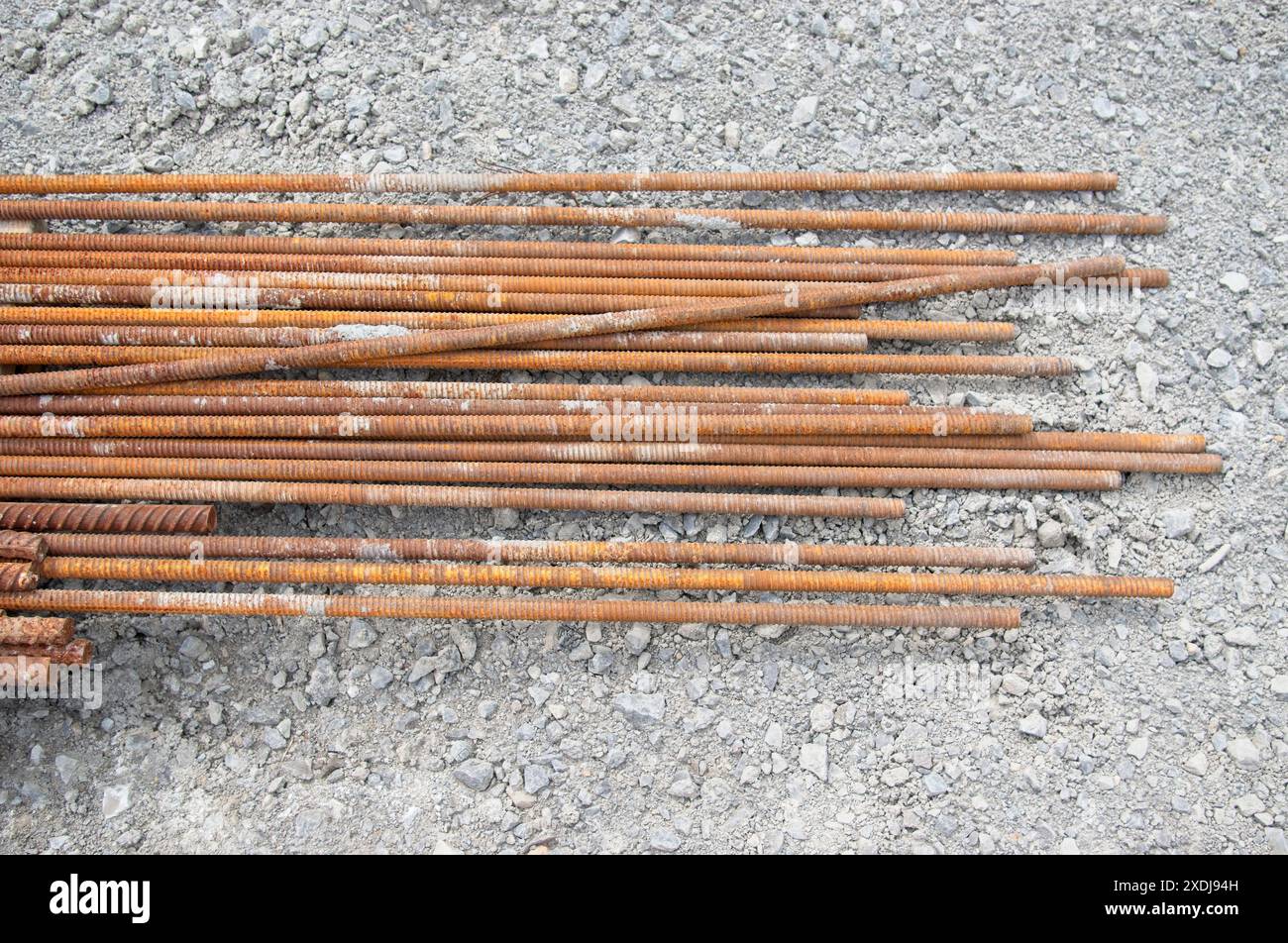 Bars of rebar laying on a gravel lot Stock Photo