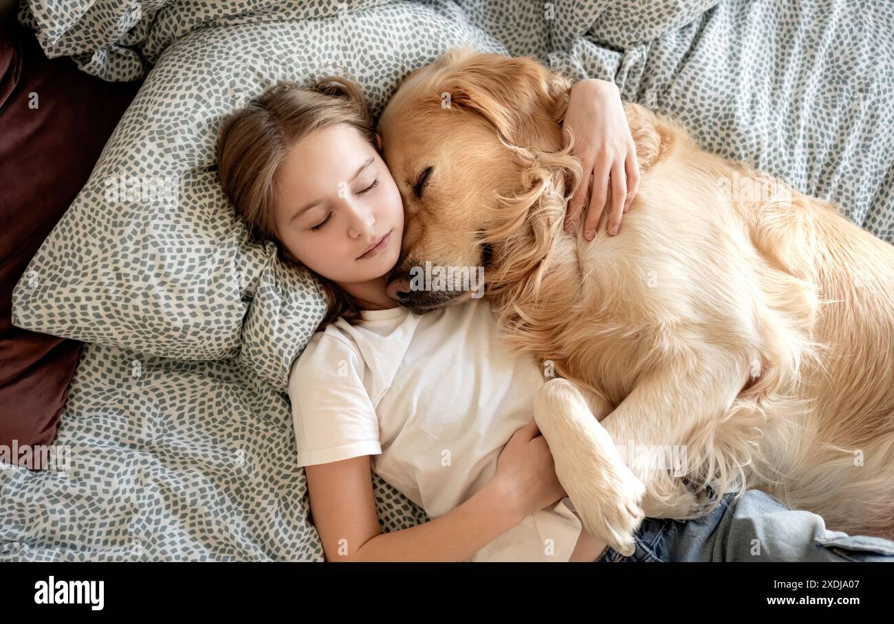 Cute Little Girl Sleeping With Dog In Embrace In Bed Stock Photo - Alamy