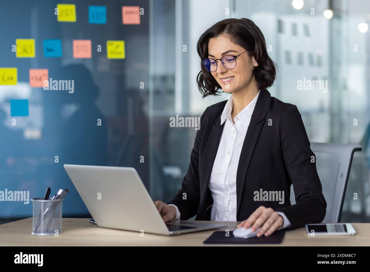 Businesswoman in black blazer hi-res stock photography and images - Alamy