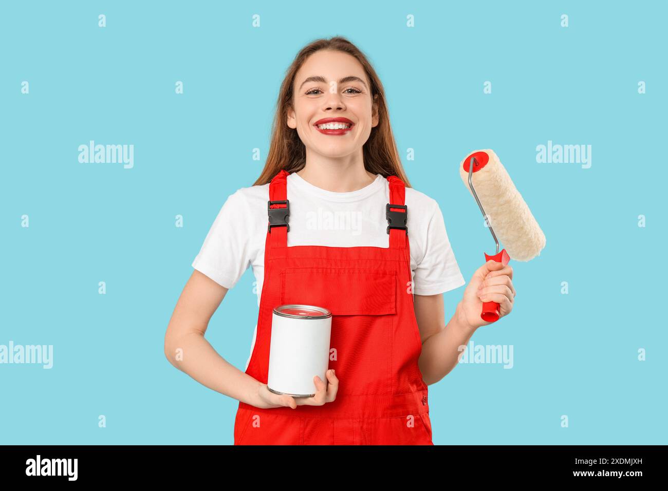 Female painter with roller and can of paint on blue background Stock ...