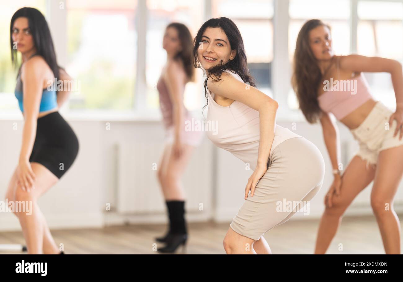 Positive slim brunette practicing jazz-funk dance in studio Stock Photo
