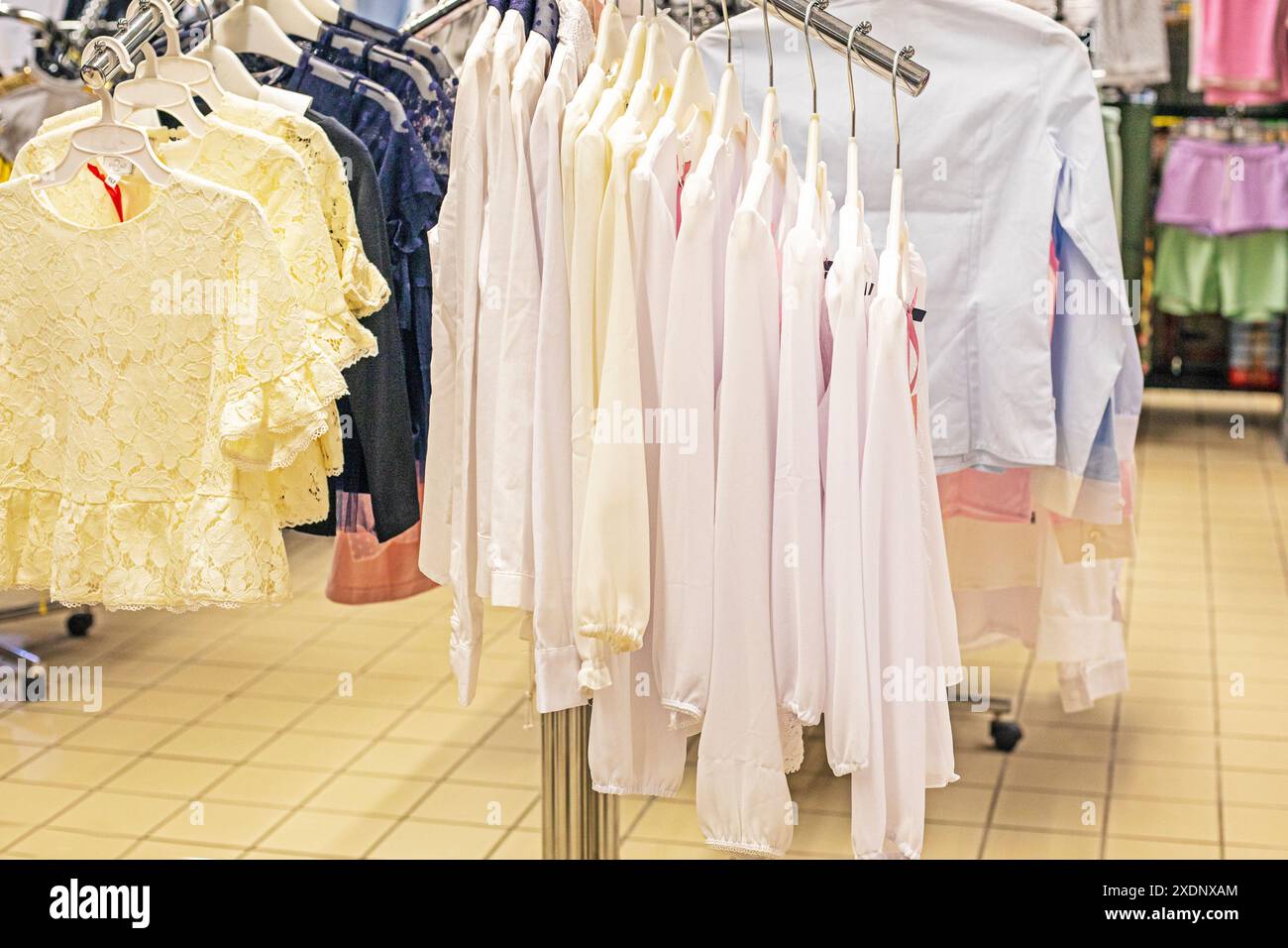 White shirts and blouses on a hanger in a store. Back to school Stock Photo