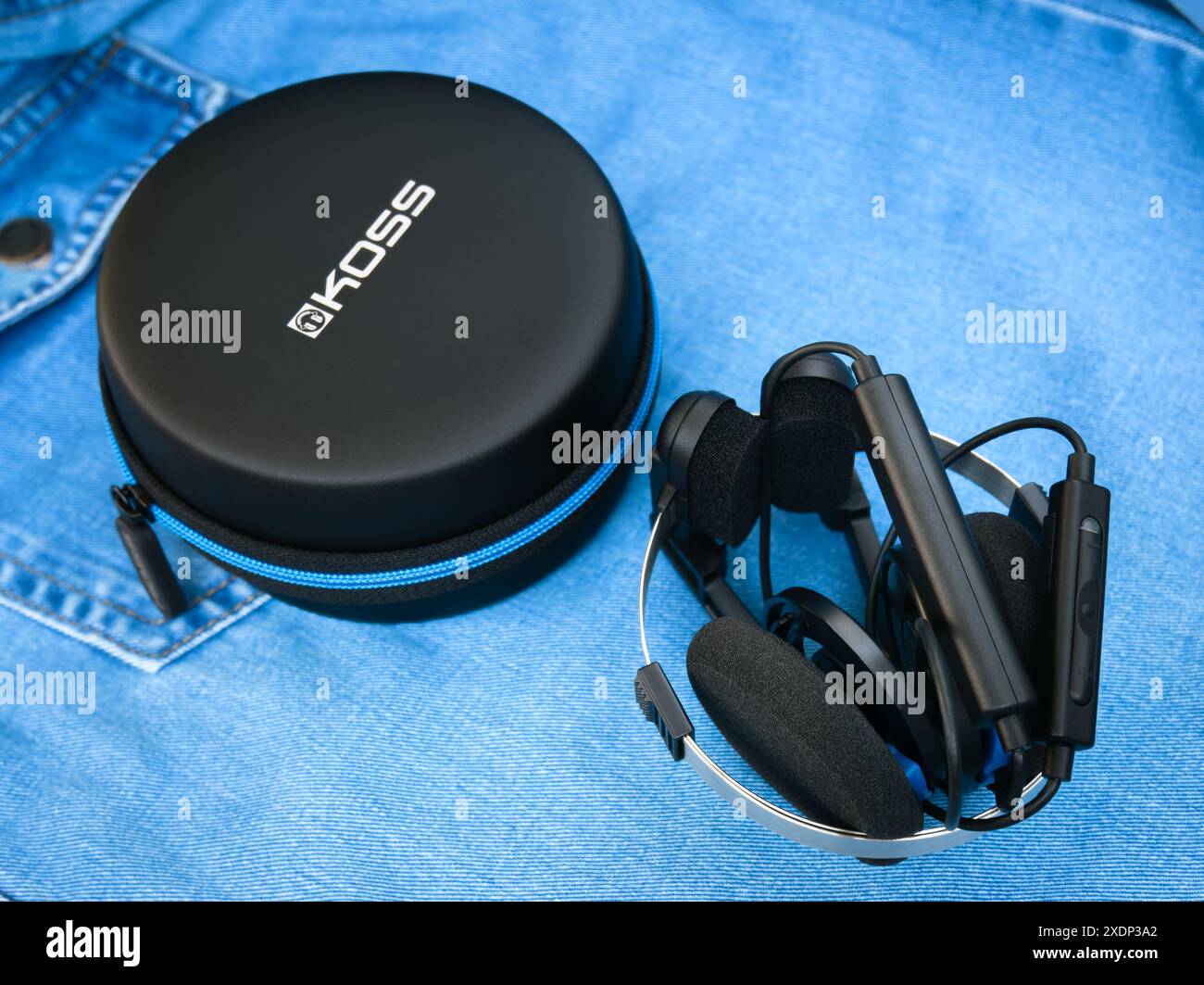 Koss Porta Pro Wireless headphones folded with a round case over a denim shirt Stock Photo Alamy