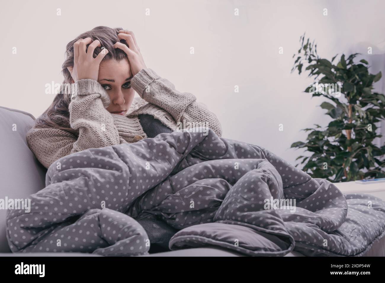 Sad young woman sits on hi-res stock photography and images - Alamy