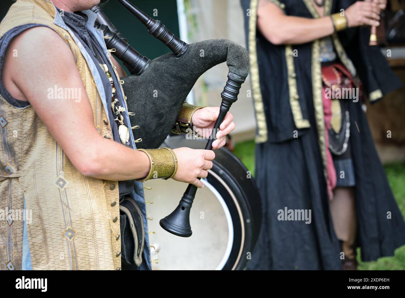 Musician playing the bagpipes made of leather and wood based on historical models, folk music band at a medieval festival, copy space, selected focus, Stock Photo