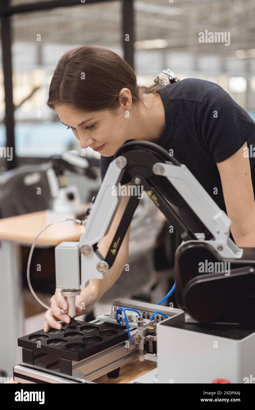 Engineer women learning education in Industrial Robotics program with robot arm simulation model in university engineering lab classroom. Stock Photo