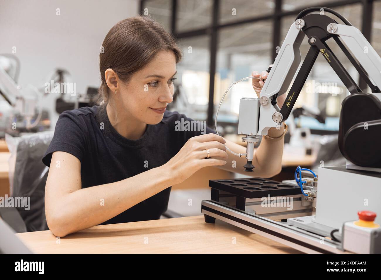 Engineer women learning education in Industrial Robotics program with robot arm simulation model in university engineering lab classroom. Stock Photo