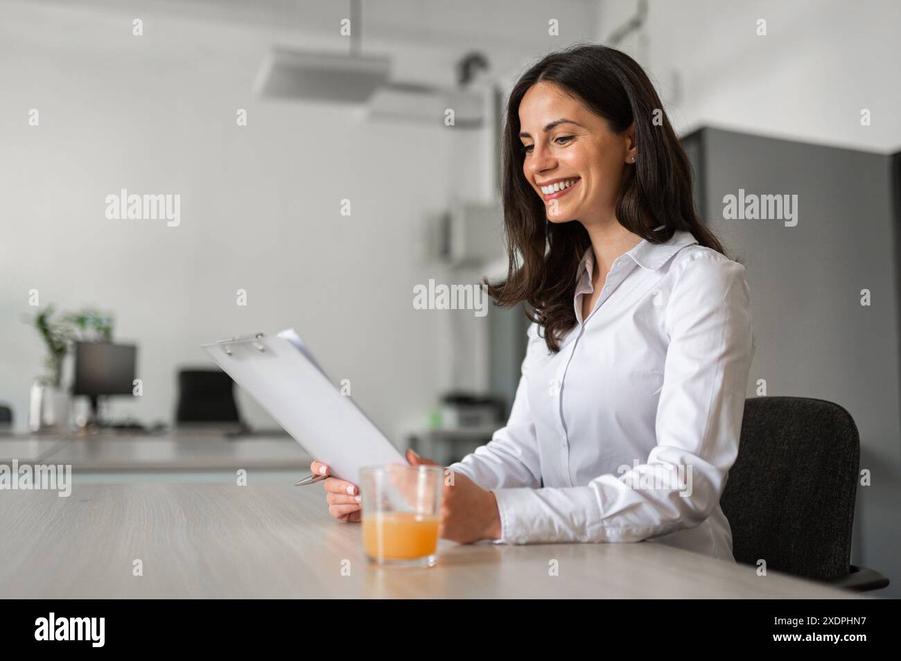 Joyfull young woman at work Stock Photo