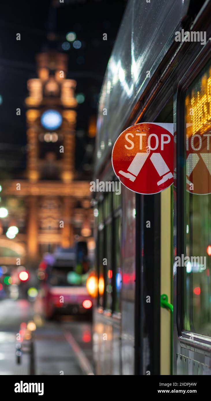 Stop Sign on Melbourne tram in the city at night Stock Photo