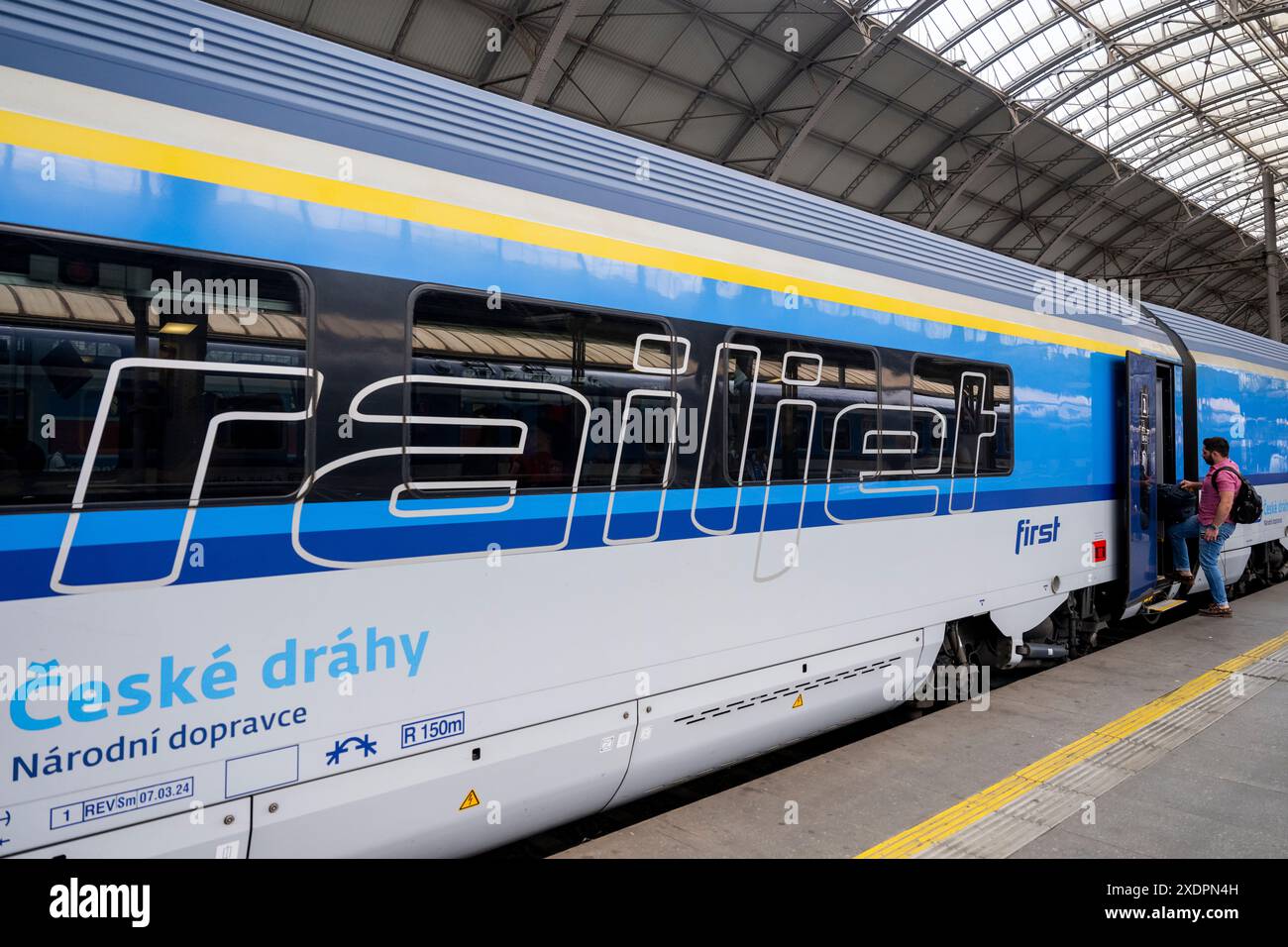 A Man Boards A Railjet Train At Main Railway Station In Prague Czech a-man-boards-a-railjet-train-at-main-railway-station-in-prague-czech