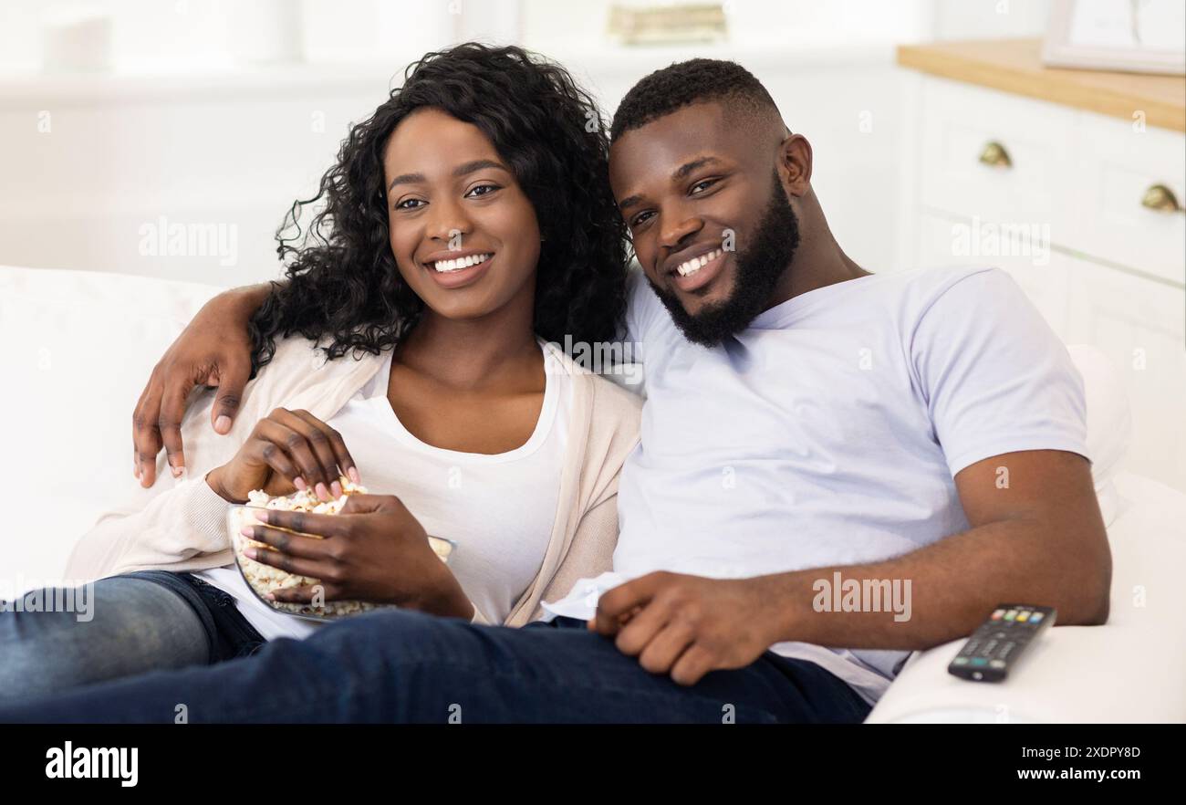 Couple Relaxing on Couch With Popcorn Stock Photo