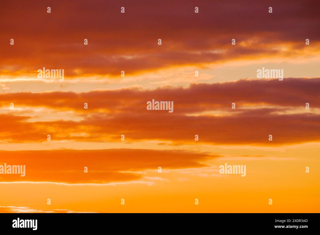 cloudy weather meteorology background. cumulus clouds on the blue sky blown by the wind. orange glow Stock Photo