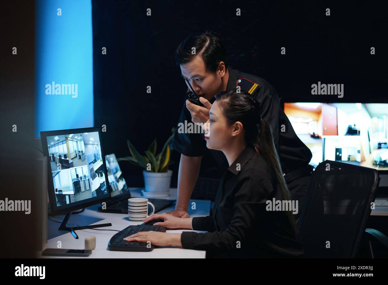 Colleagues Working In Security Room Stock Photo