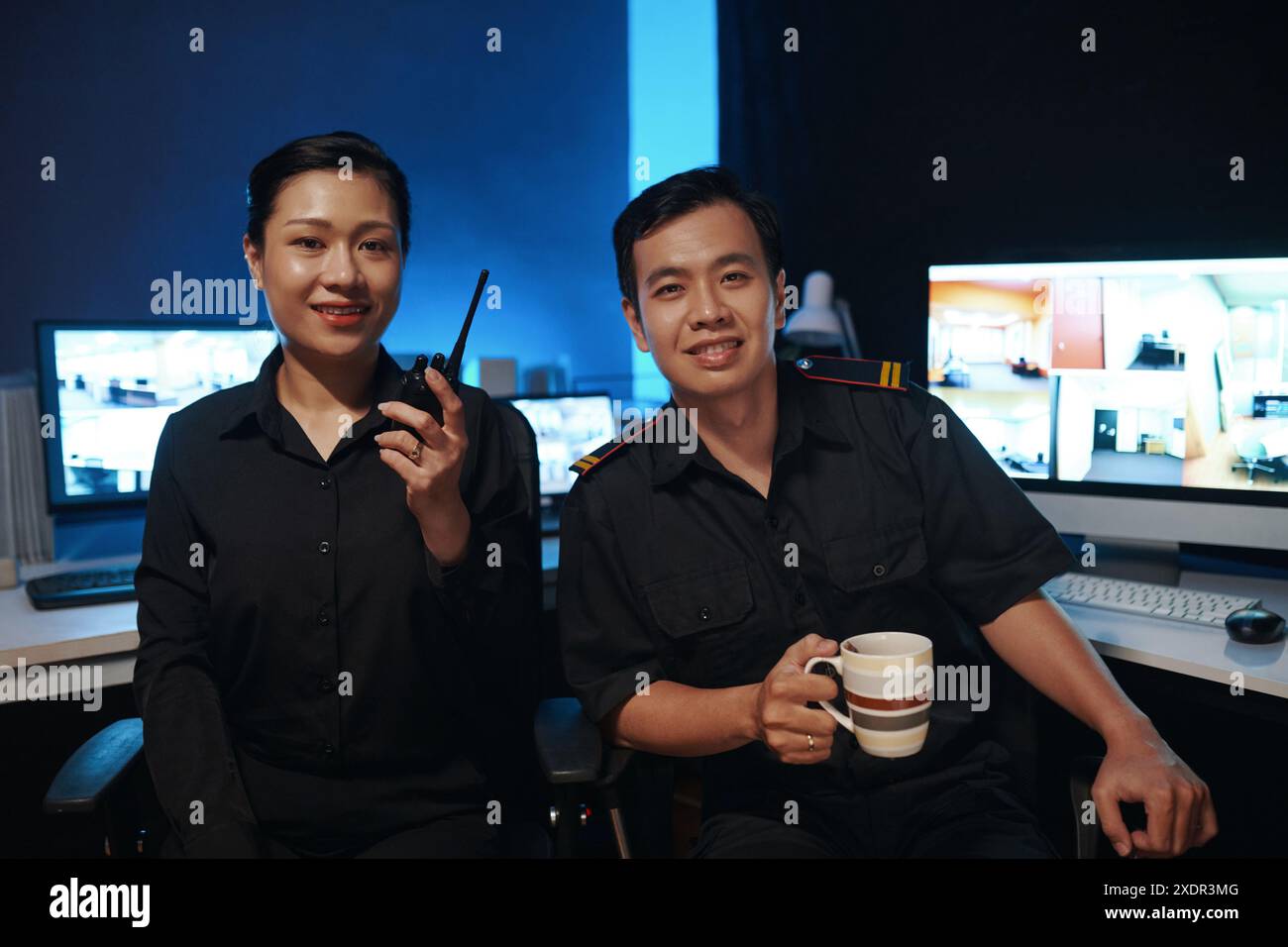 Colleagues Working In Security Post Stock Photo