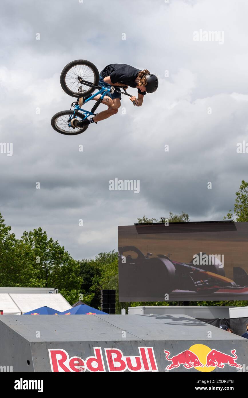 BMX stunt rider jumping high at the Red Bull Soapbox Race London event, in the park of Alexandra Palace, UK Stock Photo