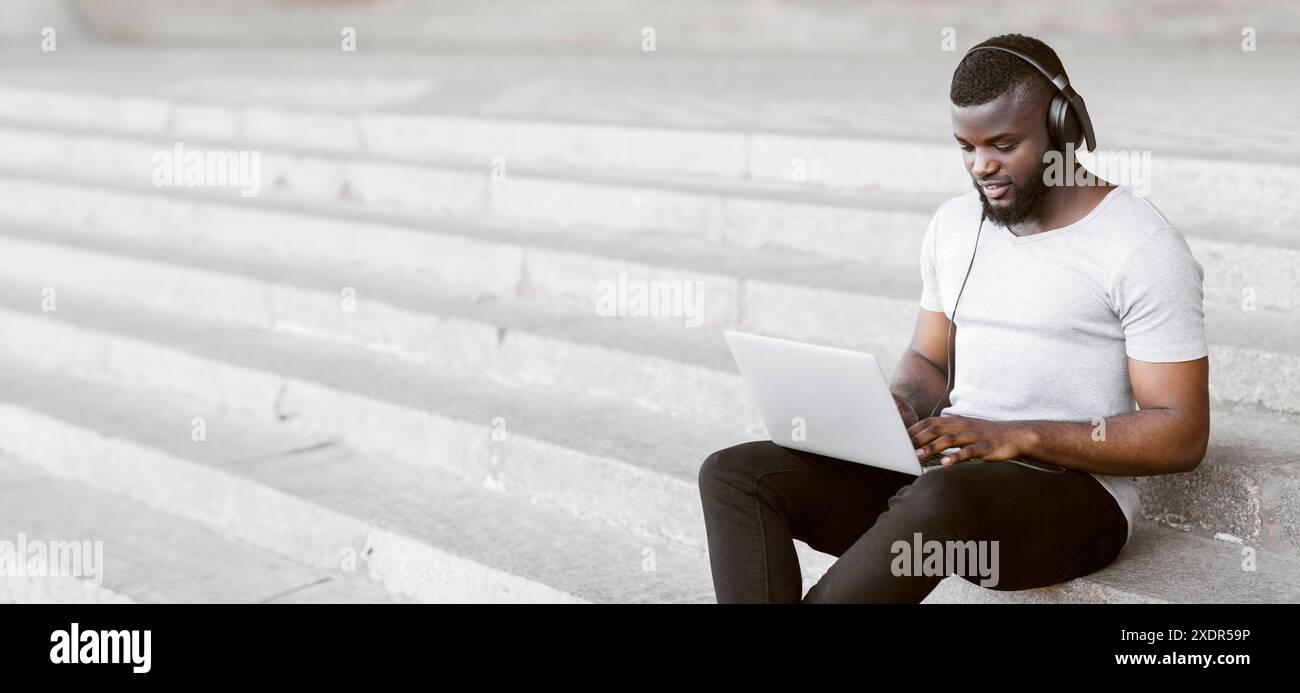 Man Using Laptop On Stairs Stock Photo