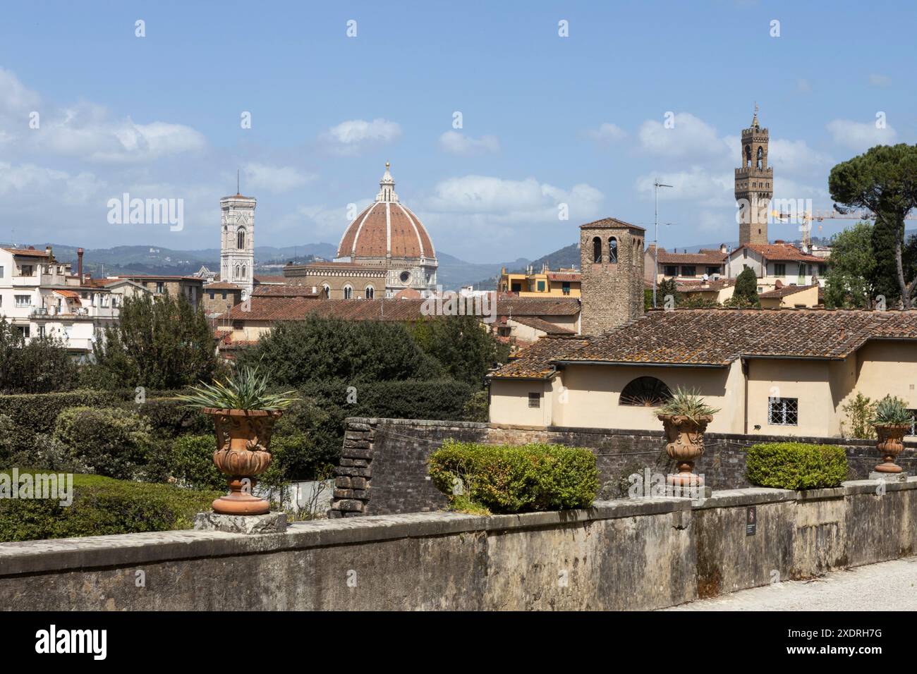 Classical urns planted with succulents on a wall at the entrance to the Boboli Gardens, with views across Florence and the Duomo. Italy Stock Photo