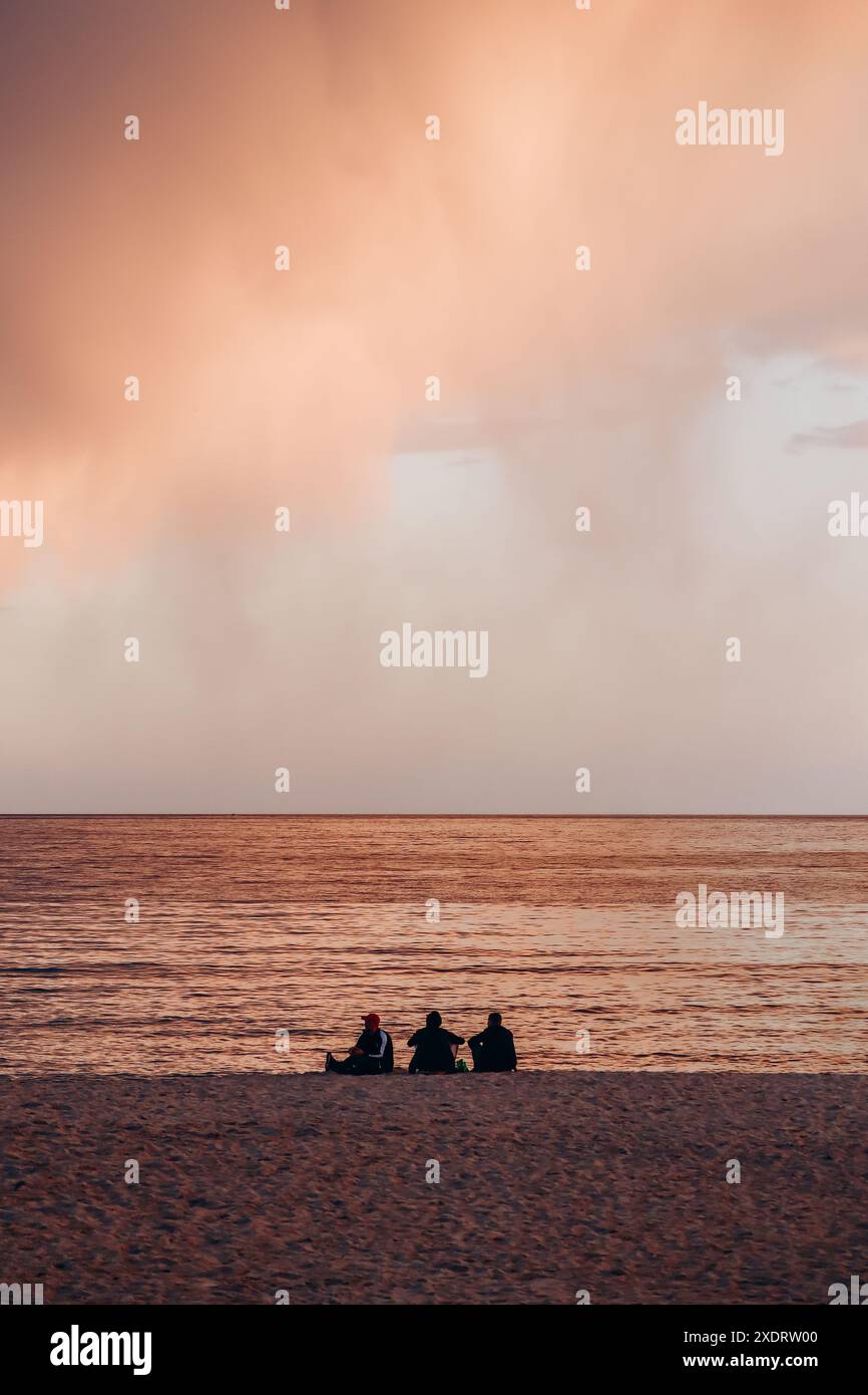 Three silhouettes on the beach in Cannes at sunset Stock Photo - Alamy