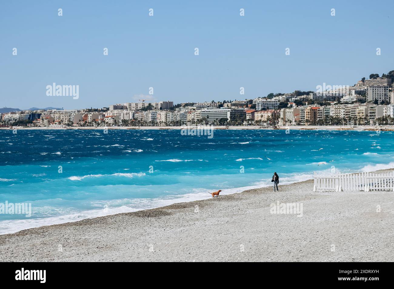Nice, France - 21 April 2024: People walking on the beach in Nice in ...