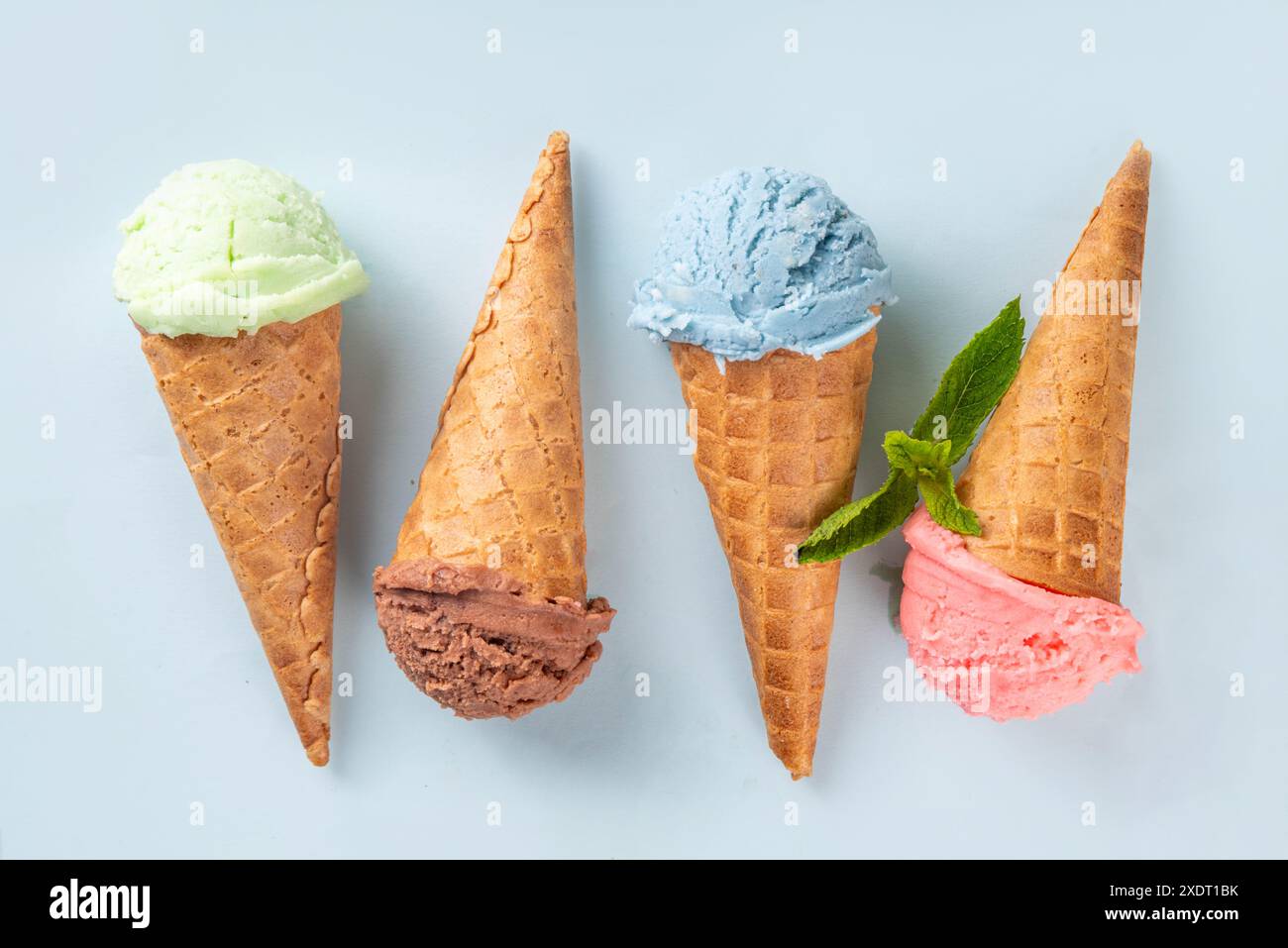 Colorful bright ice cream in waffle cones on bright background. Variety ...