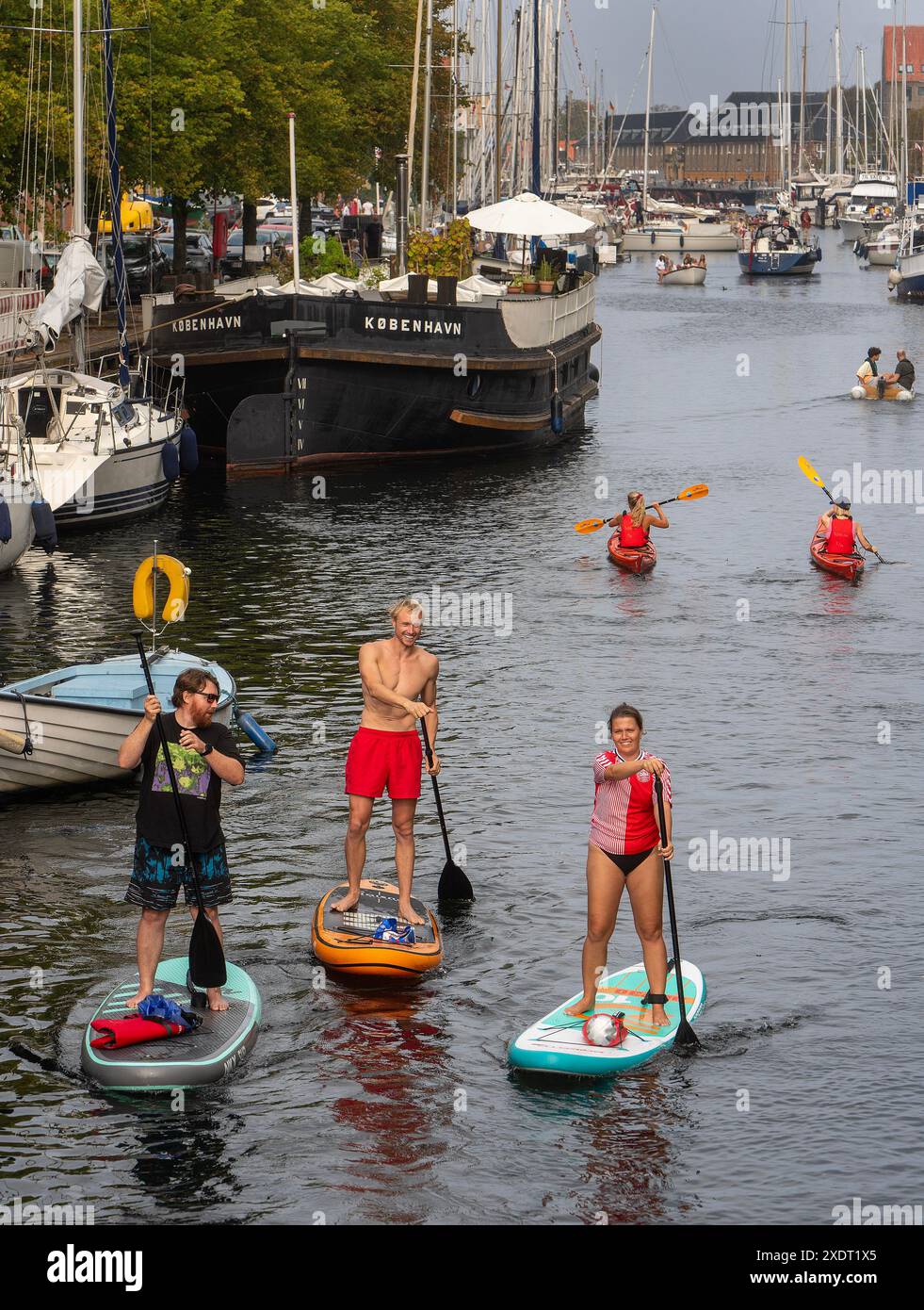 Paddle boarders and kayaker at a Copenhagen canal,Denmark Stock Photo