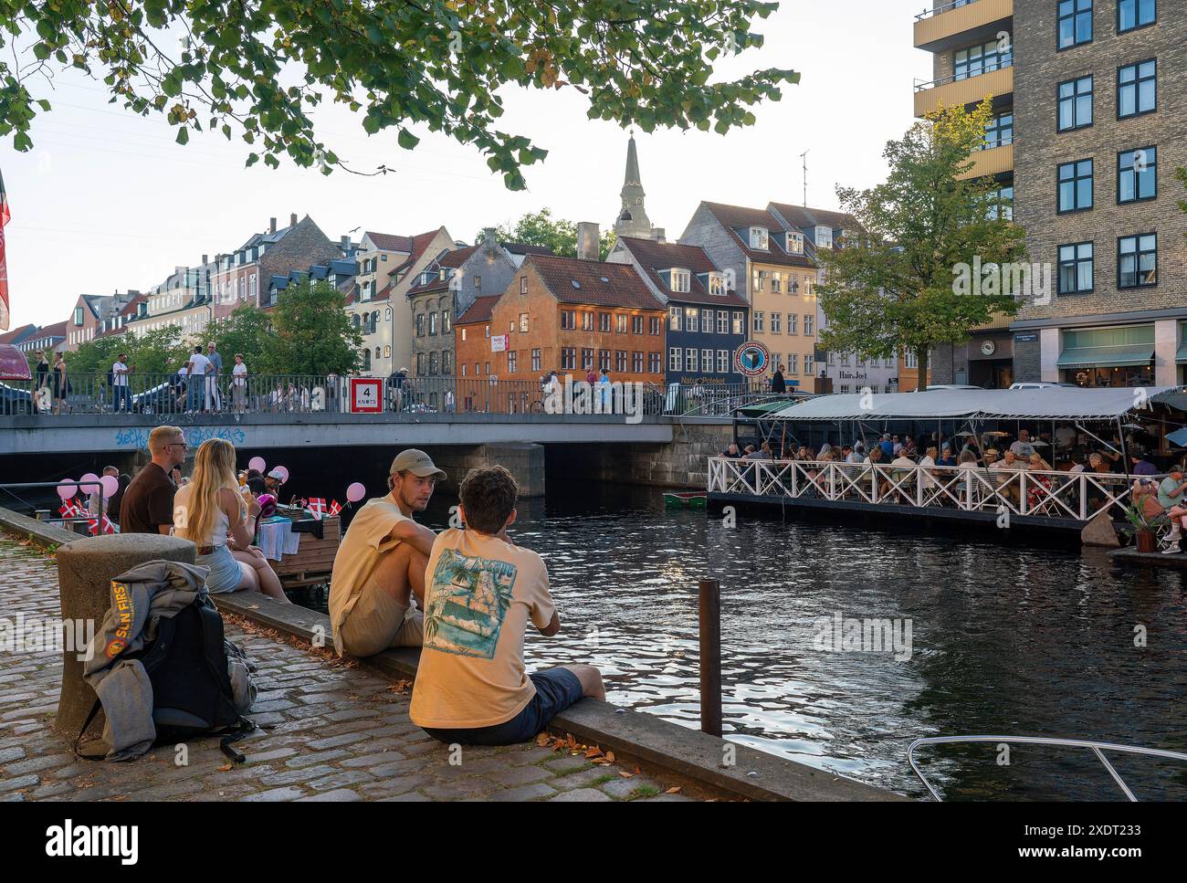People sitting by the Christianshavn canal,Copenhagen,Denmark Stock Photo