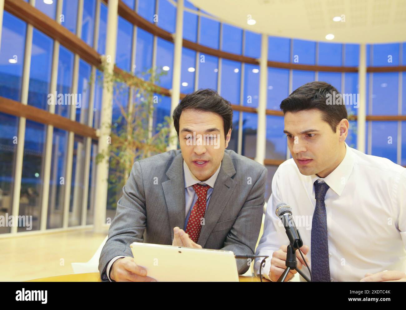 Executives with digital tablet, video conference Stock Photo