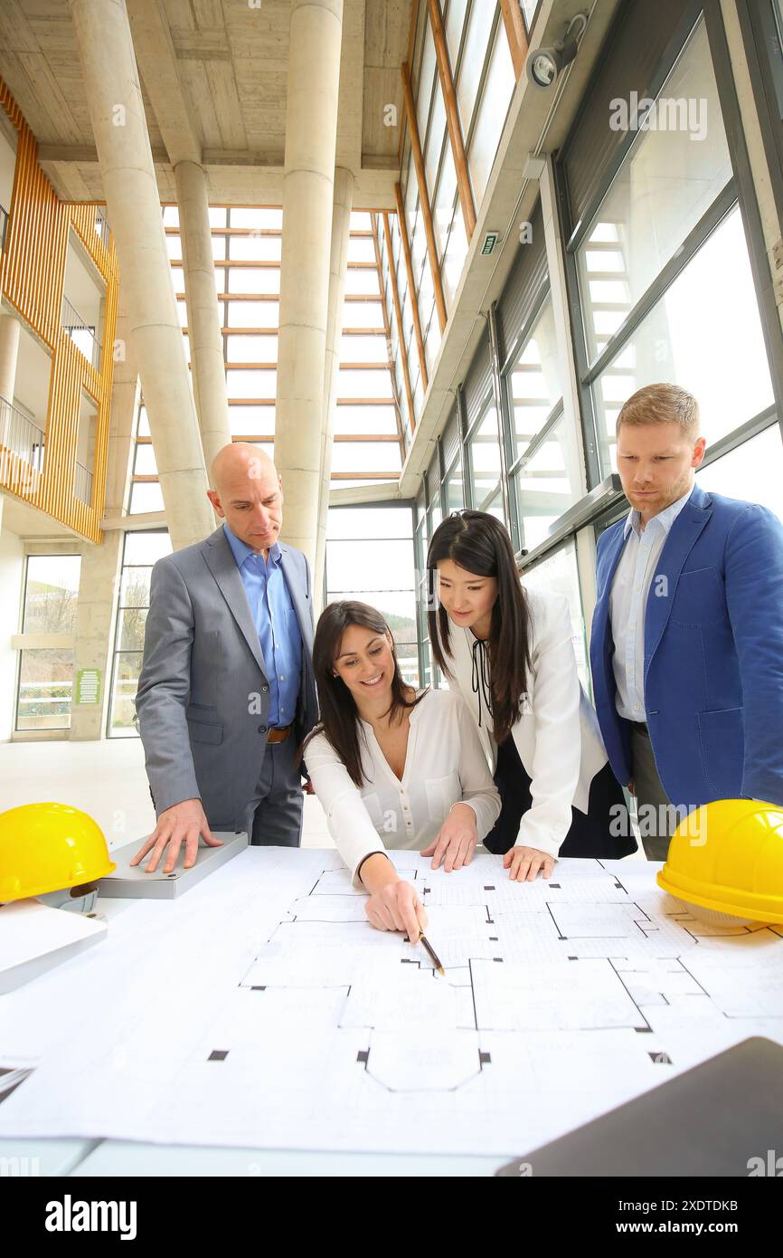 Architects looking at blueprints Stock Photo