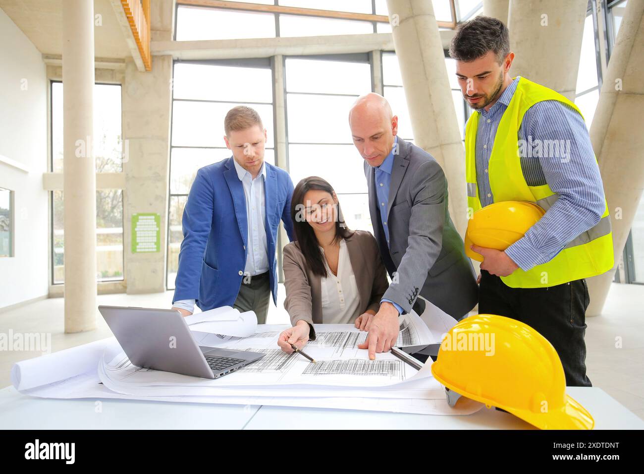 Architects looking at blueprints Stock Photo