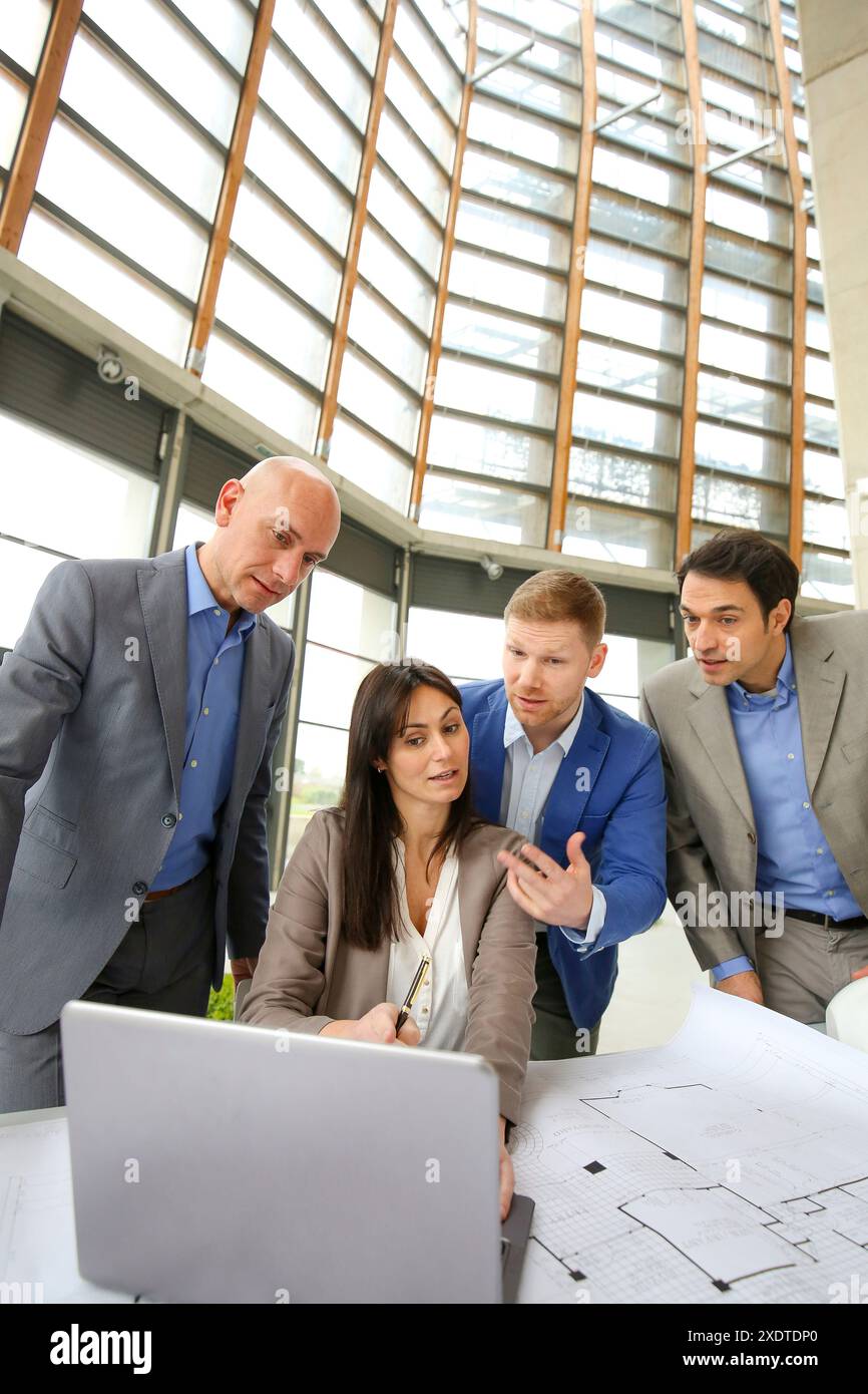 Architects looking at blueprints Stock Photo