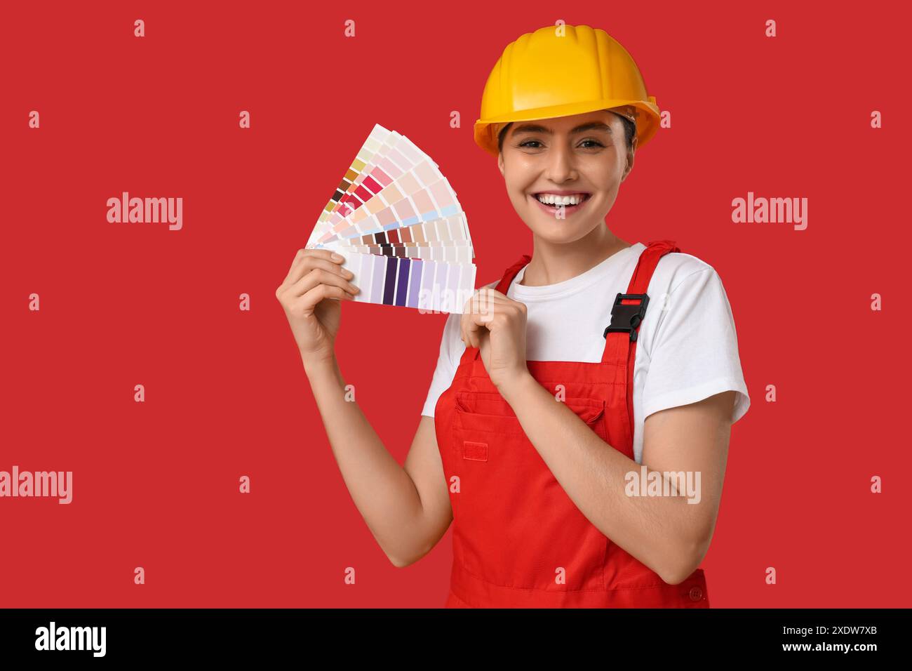 Female painter with color palettes on red background Stock Photo - Alamy