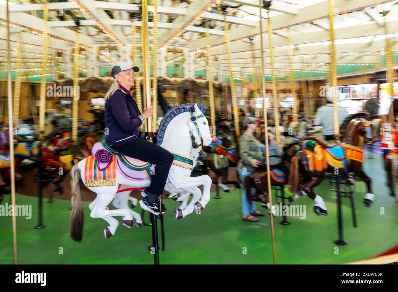 Lone senior female riding the 1911 Looff Carousel; National Historic ...