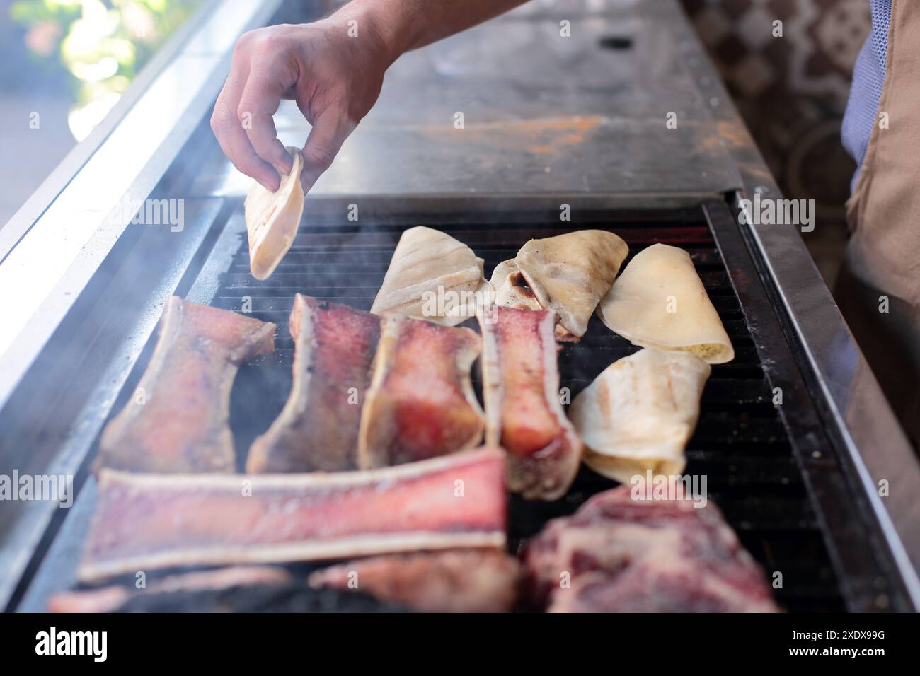 Man places quesadillas on the grill Stock Photo