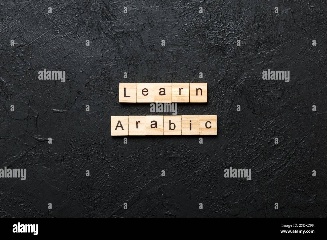 learn arabic word written on wood block. learn arabic text on table ...