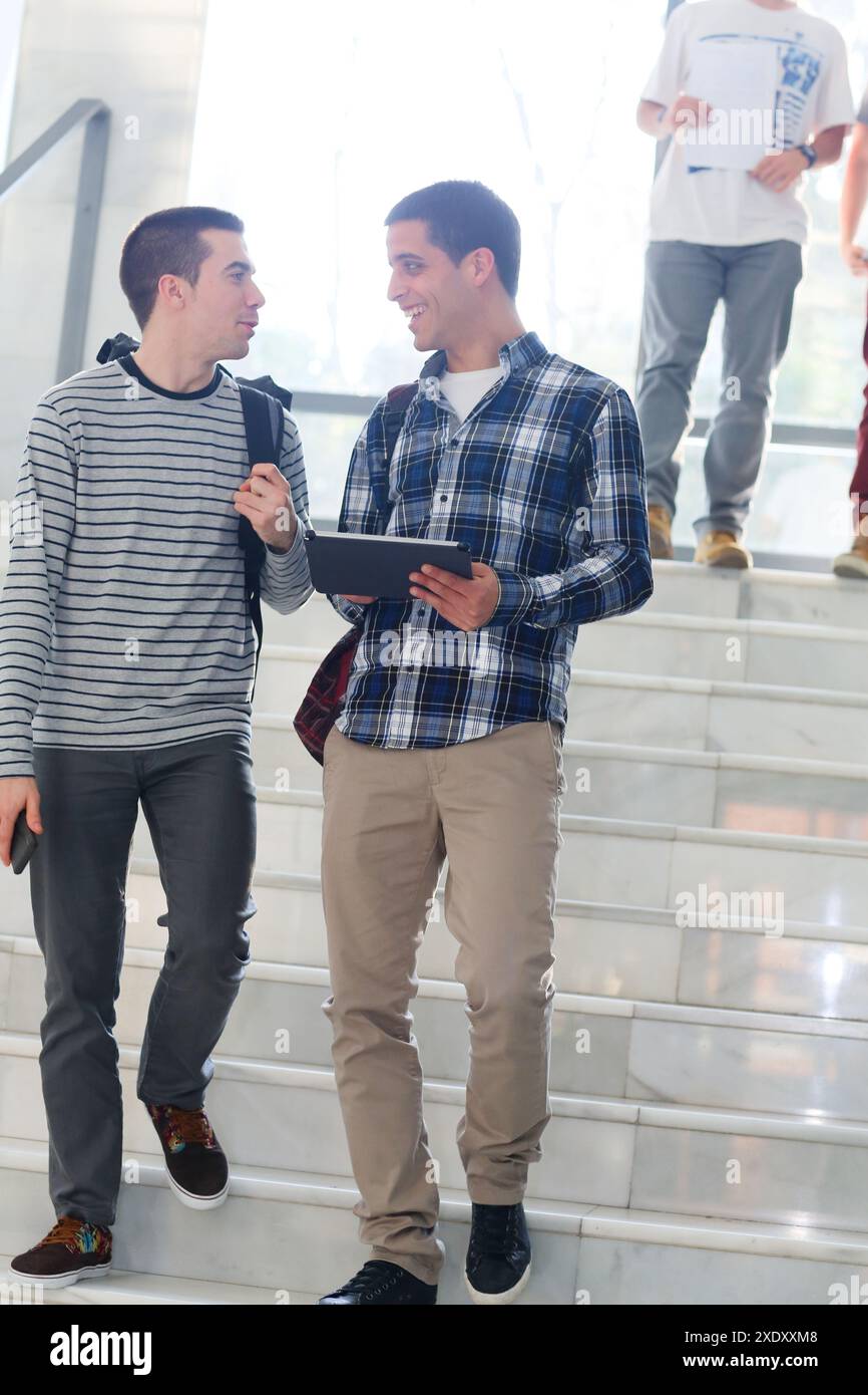 Young students at campus using digital tablet Stock Photo