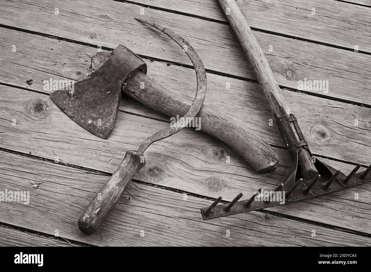 The ax, sickle and rake are the old hand tools Stock Photo - Alamy