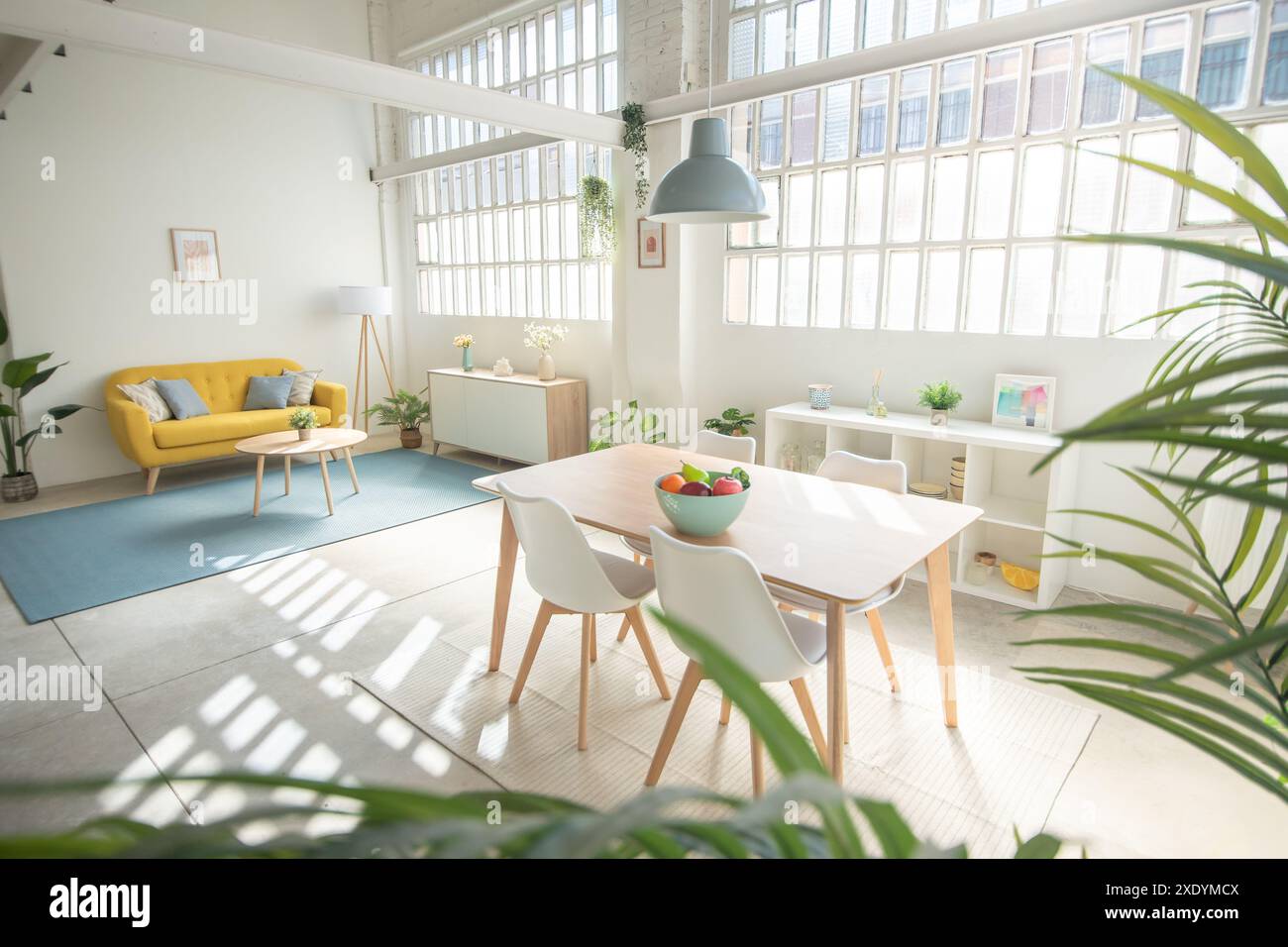 Interior design featuring a yellow couch, table, and chairs in a living ...