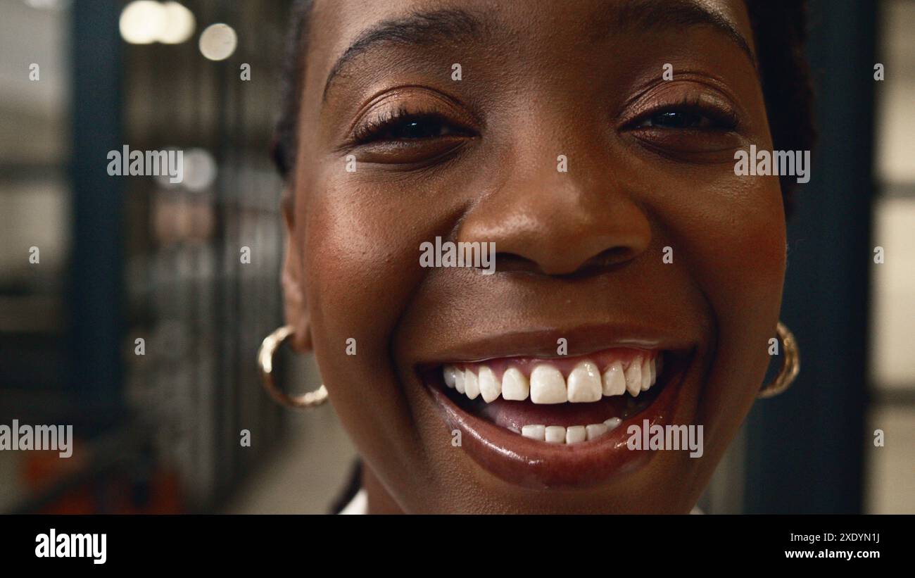 Close-Up of a Smiling Black Woman in Modern Industrial Office Setting ...
