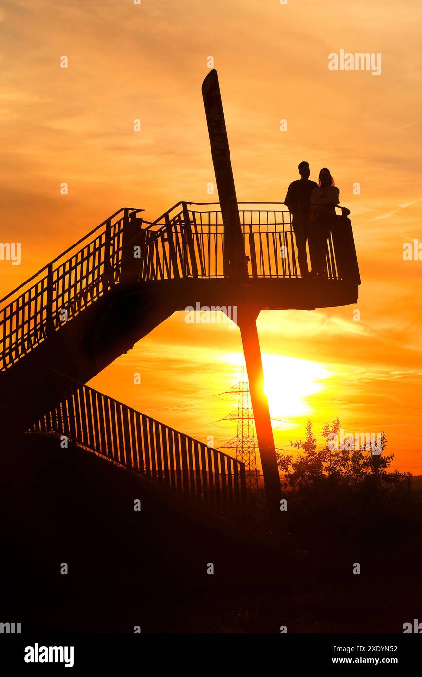 Viewing platform at the Pluto spoil tip with a couple at an atmospheric sunset, Germany, North Rhine-Westphalia, Ruhr Area, Herne Stock Photo