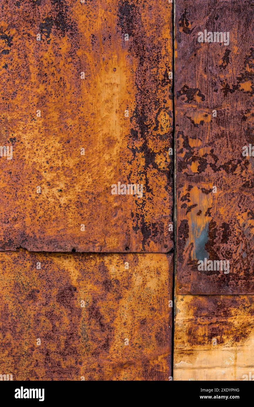 Rusted flat composite nailed metal sheets surface background and texture. Stock Photo