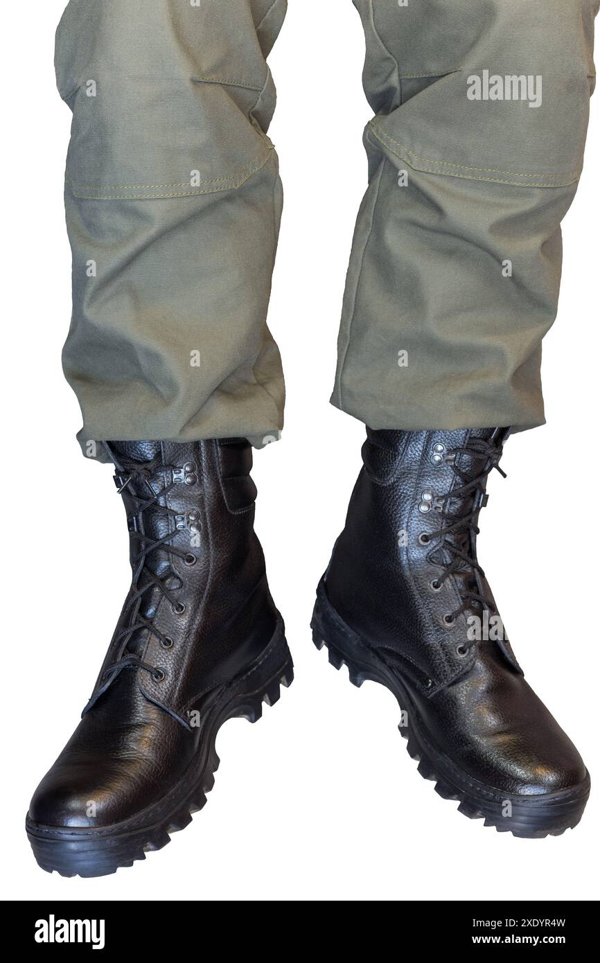 Legs in army khaki pants and military boots Stock Photo