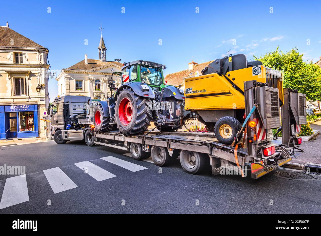 Long articulated lorry carrying farm tractor and machinery - Preuilly-sur-Claise, Indre-et-Loire (37), France. Stock Photo
