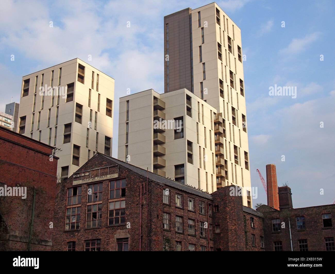 Modern highrise apartment developments behind old abandoned industrial buildings in manchester city centre Stock Photo