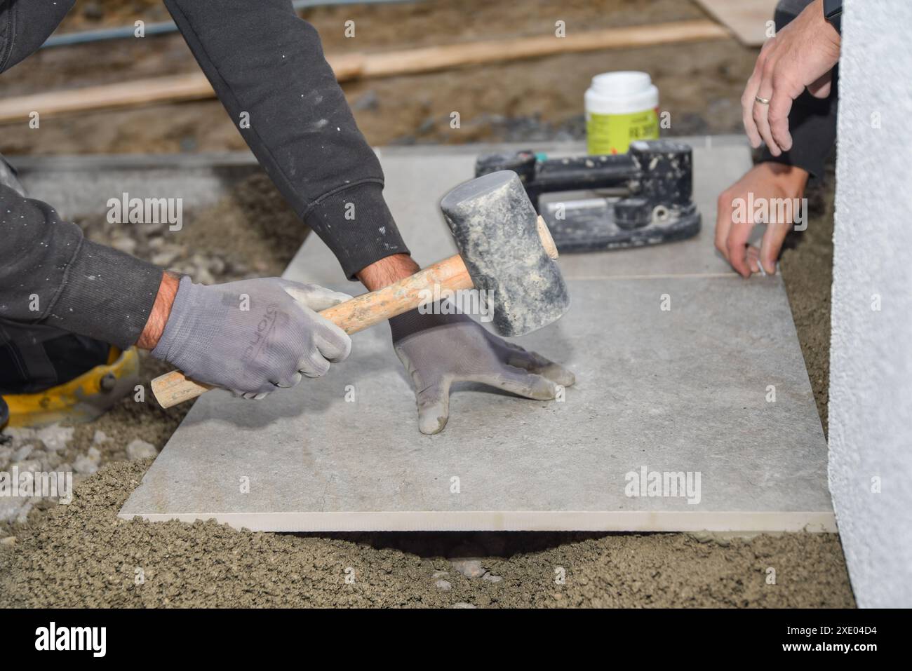 Tiler works on a construction site - craft Stock Photo