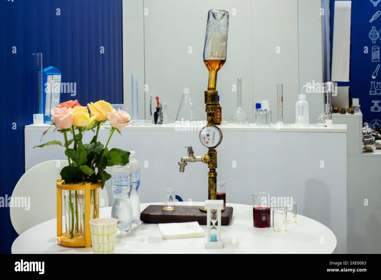 Faucet with a bottle on the background of laboratory dishes Stock Photo