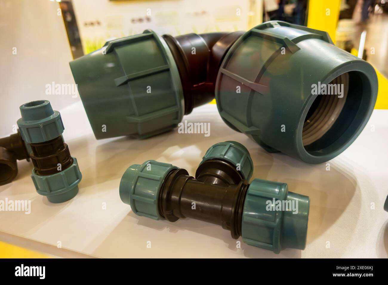 Curved plastic connector for connecting watering hoses to each other