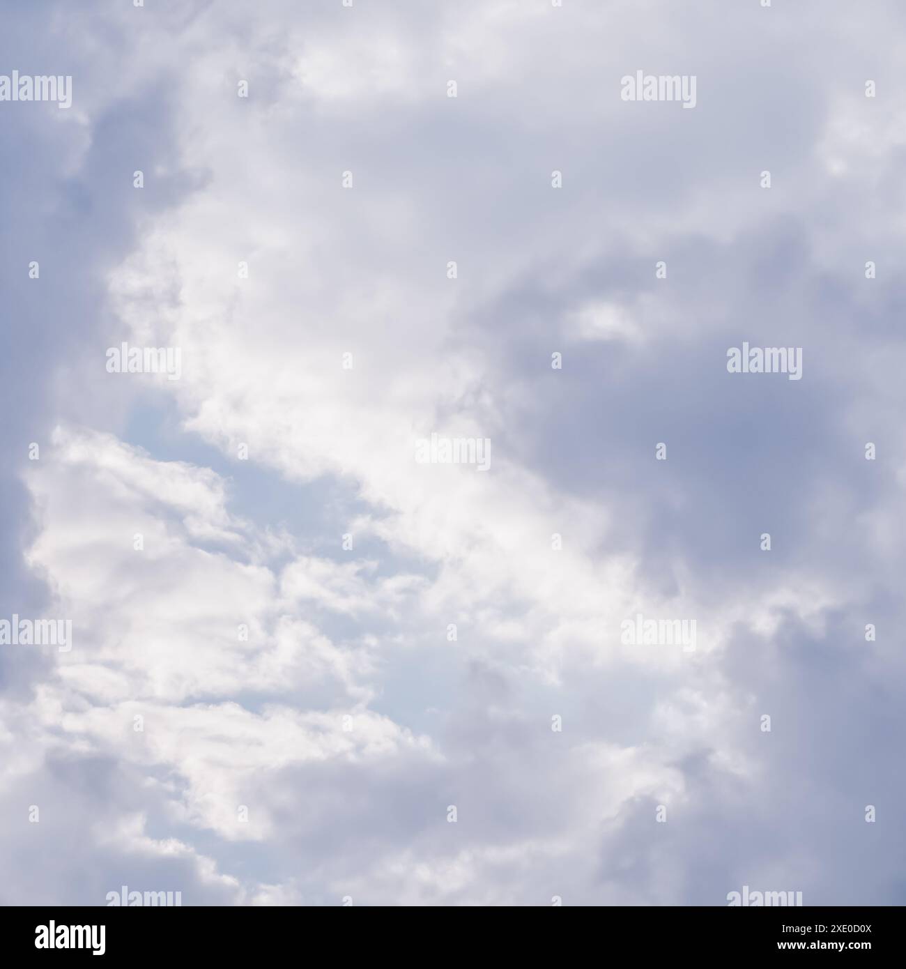 Cloudy sky background. Sunlight shining through white clouds. Stock Photo